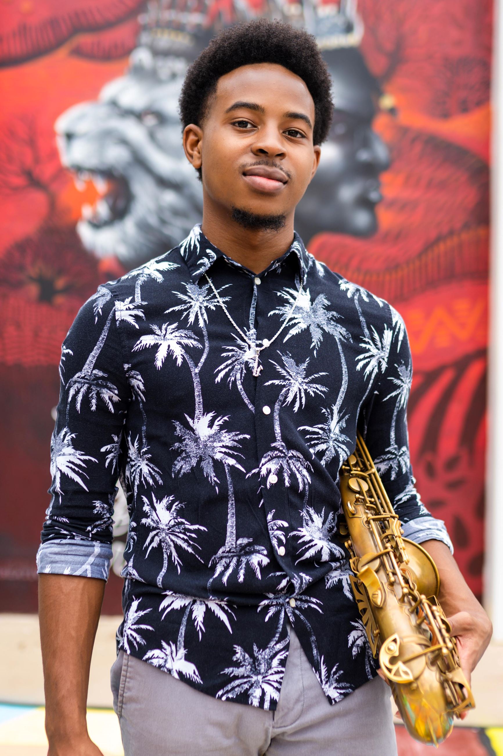 Young man holding a saxophone