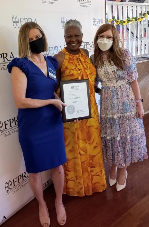 Three women at an awards ceremony