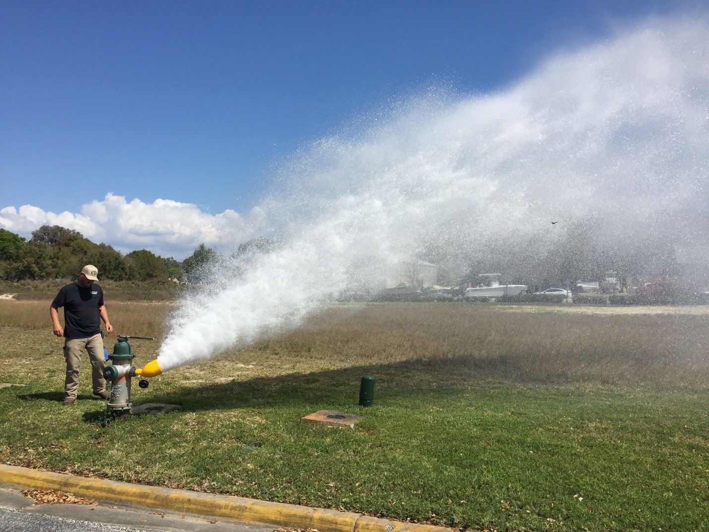Person flushing and testing fire hydrant.