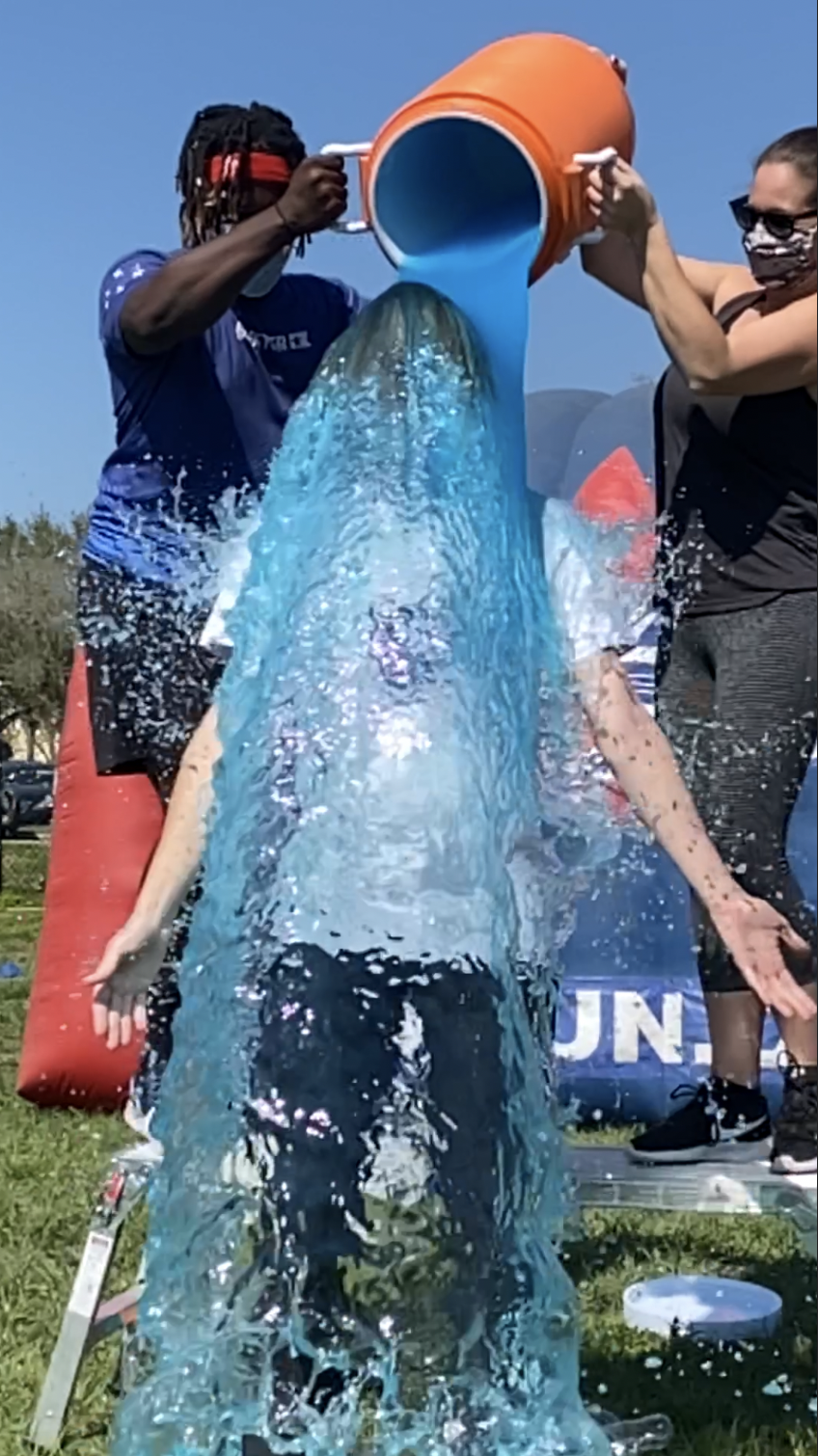 A male teacher getting blue gatorade dumped on him.